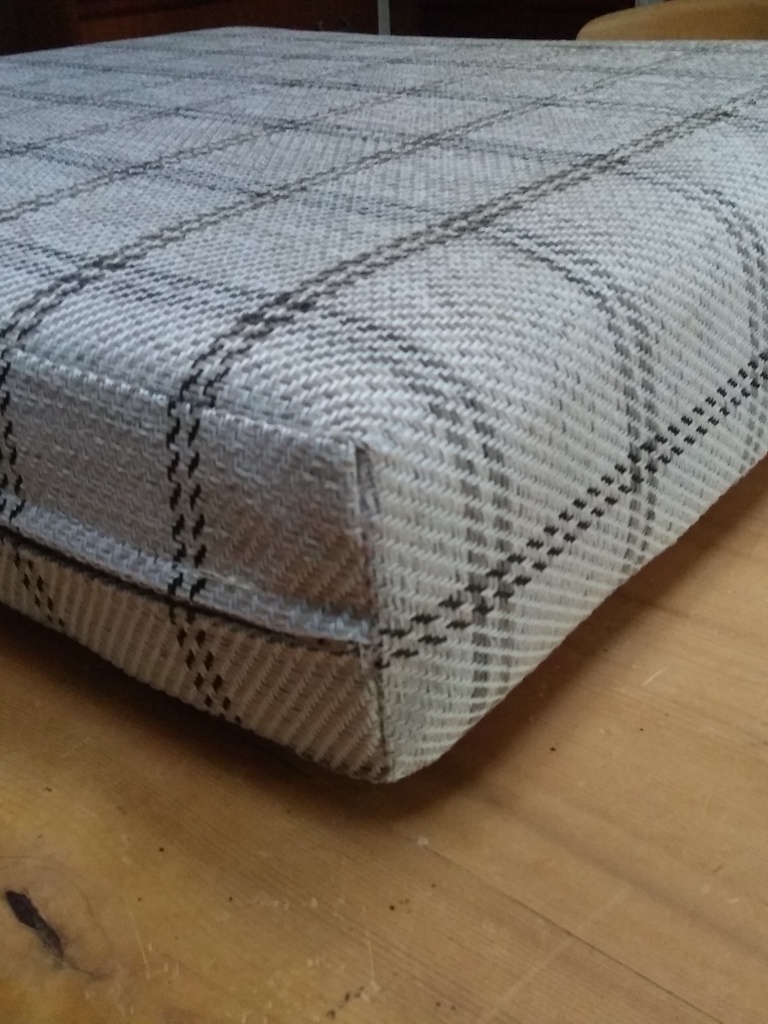 Corner detail of campervan cushion with aligned check pattern