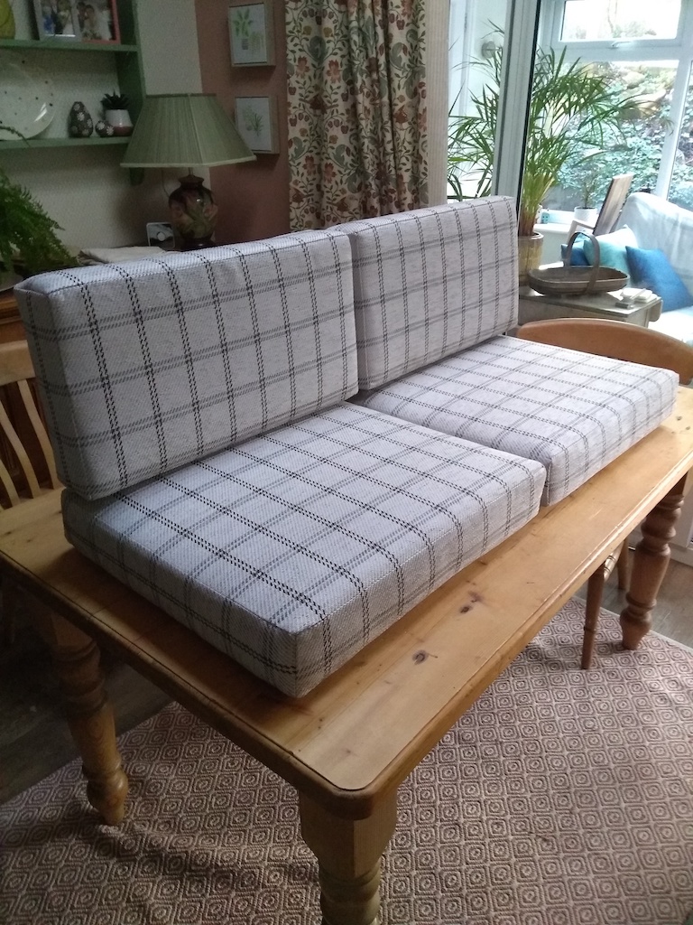 Four checked campervan cushions