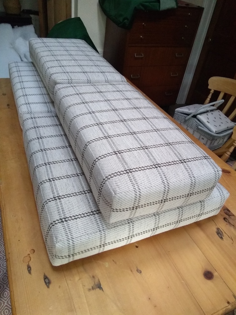 Checked campervan cushions in a pile